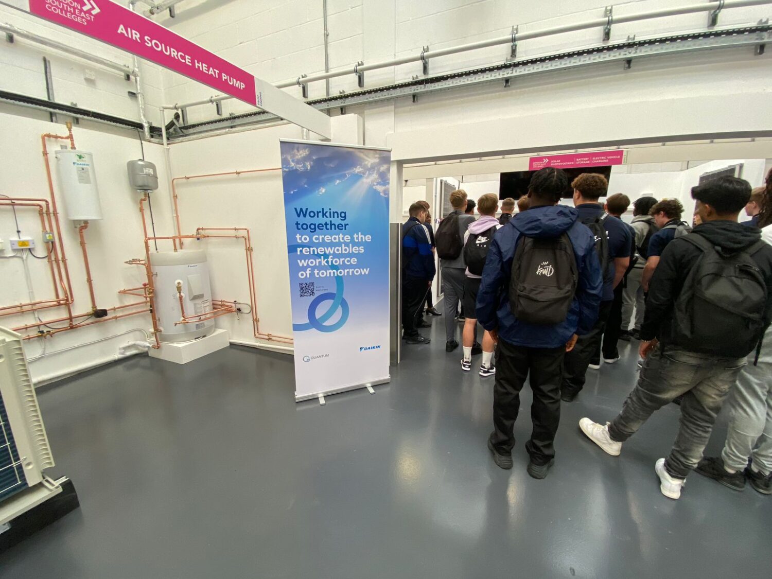 A crowd looks on as one of the new booths is unveiled at LSEC Bromley Green Skills Lab